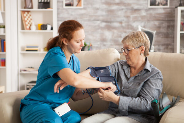 female-nurse-using-digital-blood-pressure-device-senior-woman-nursing-home female-nurse-using-digital-blood-pressure-device-senior-woman-nursing-home